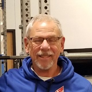Steve, a smiling Wave Medical Center patient in glasses and a blue hoodie