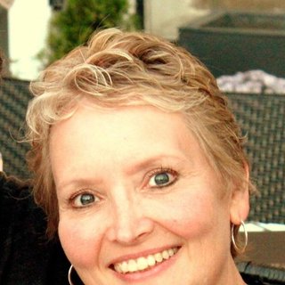 Susan, a smiling Wave Medical Center patient with short blonde hair